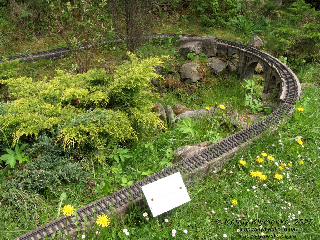Photo of the Carpathians, Ivano-Frankivsk region. Yaremche. Park-Museum “Carpathians in Miniature”. Railway and stone railway bridge - viaduct (1894).