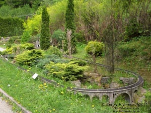 Photo of the Carpathians, Ivano-Frankivsk region. Yaremche. Park-Museum “Carpathians in Miniature”. Railway and stone railway bridge - viaduct (1894).